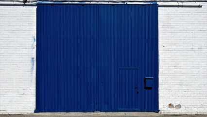 blue industrial door on white facade