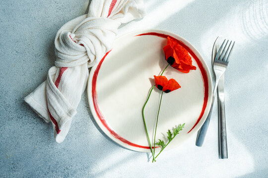 Summer table setting with red poppy