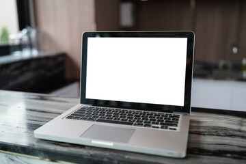 Fototapeta premium Laptop with Mock up blank screen on table in front of cafe space for text. product display computer laptop montage- technology concept