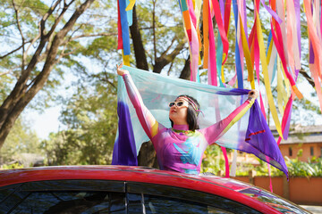 Happy Asian woman support LGBT pride parade in car. with Rainbow of LGBTQ or LGBTQIA.