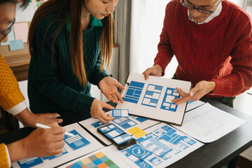 Fototapeta premium Asian businessman and woman people meeting in office. Employee brainstorm and work as team, plan and discuss project by point on paper and tablet. .