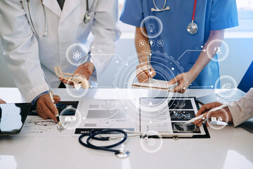 Medical technology network team meeting concept. Doctor hand working with smart phone modern digital tablet and laptop computer with graphics chart interface, with virtual icon .