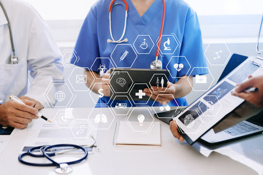 Medical technology network team meeting concept. Doctor hand working with smart phone modern digital tablet and laptop computer with graphics chart interface, with virtual icon .