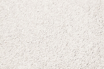 the white texture of a plaster or wall with small indentations.