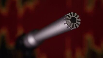 Condenser measurement microphone on audio waves background