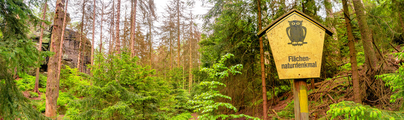 Panoramic over sign saying in German area of natural monument, in magical enchanted fairytale...
