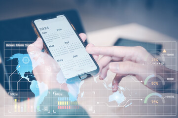 Concept of time management financial planning and reminder for 2024. man using smartphone working with calendar 2024, business planning marketing and investment, schedule appointment meeting