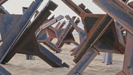 Military Defensive Anti Tank Infantry Metal Obstacles Preventing Sea Invasion Landing Deployed on Beach © rohawk