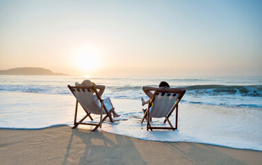 Couple sunbathing on a beach chair.