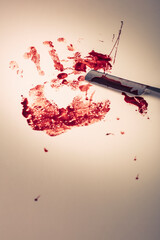 Bloody handprint and razor