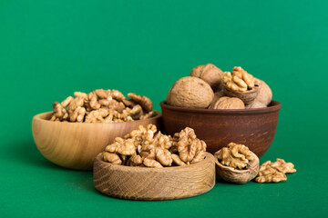 Fresh healthy walnuts in bowl on colored table background. Top view Healthy eating bertholletia concept. Super foods