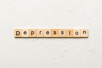 Depression word written on wood block. Depression text on table, concept