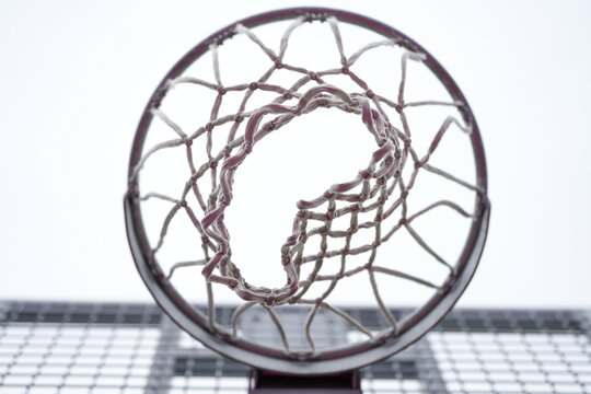 basketball hoop. detail. the net of a basketball hoop photographed from below.