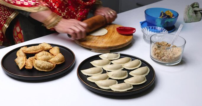 Gujiya is a classic north Indian sweet of crisp flaky pastry filled with khoya ( Milk solids ) and nuts stuffing, generally fried. This traditional sweet is enjoyed during Holi and Diwali festivals.