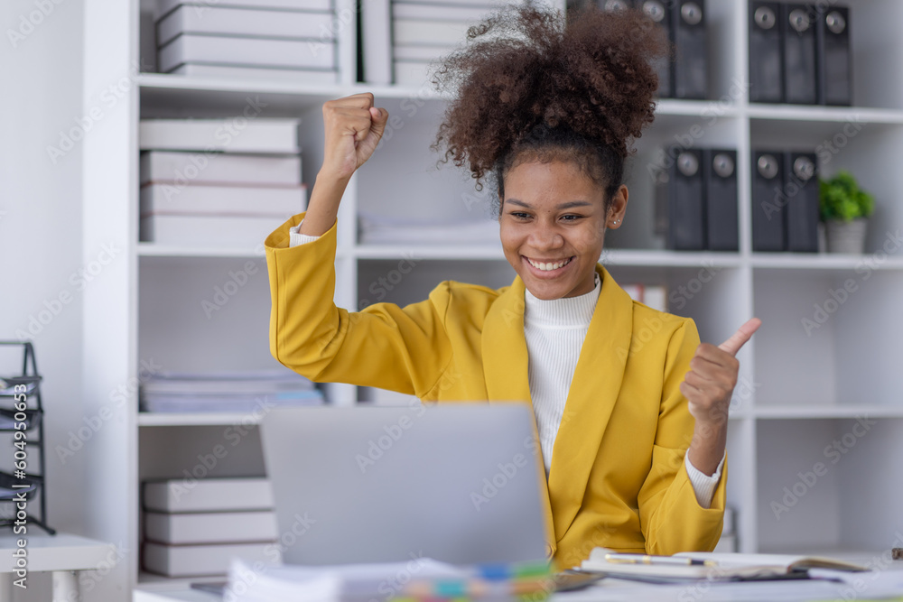 Wall mural Excited african american woman sit at desk feel euphoric win online lottery, happy black woman overjoyed get mail at tablet being promoted at work, biracial girl amazed read good news at computer