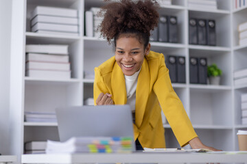 Excited african american woman sit at desk feel euphoric win online lottery, happy black woman...