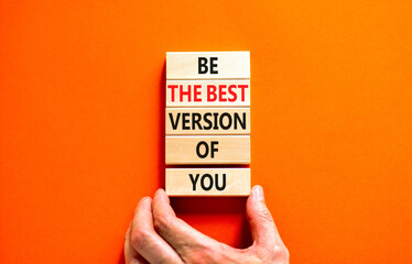 Motivational and inspirational symbol. Concept words Be the best version of you on wooden block. Beautiful orange background Businessman hand. Business motivational inspirational concept. Copy space.