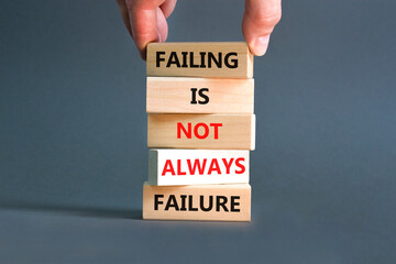 Failure or failing symbol. Concept words Failing is not always failure on wooden block. Beautiful grey table grey background. Businessman hand. Business, failure or failing concept. Copy space.