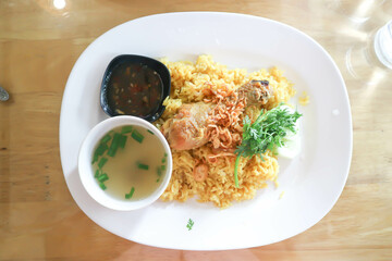 chicken rice or spiced rice steamed with chicken, rice topped with chicken