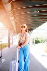 Happy tourist with sun glasses at the train station