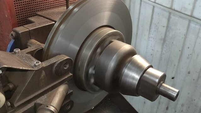 Car brake disc sanding on a lathe machine. Elimination of runout of brake discs