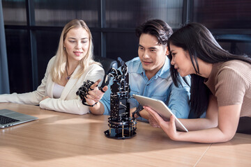 group of friends of students of various nationalities sat in the library of the university to study robot hand control.