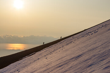 hiking with his wife on steep and sloping mountains at sunrise
