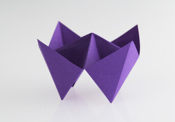 Origami paper fortune on white background