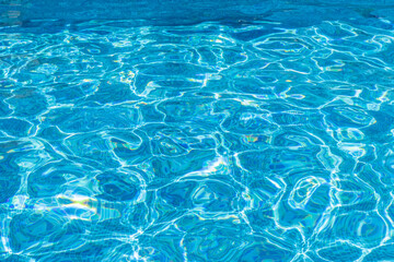 Fototapeta na wymiar Ripple Water in swimming pool witn sun reflection