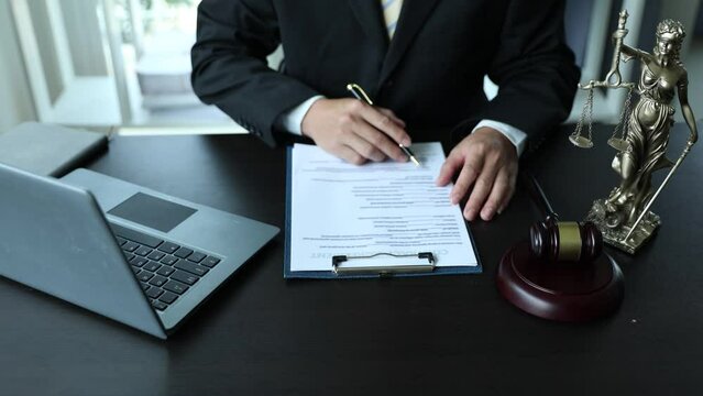 Court of Justice and Judicial: Male Lawyer Writes Argument for Defense Strategy Attorney lawyer fights for client freedom with supporting evidence. Close up.