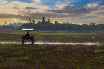 Fototapeta premium Agricultural technology The machine is spraying pesticides in the field.