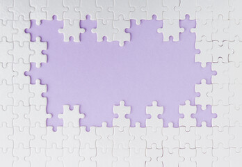 Pieces of jigsaw puzzle on purple background