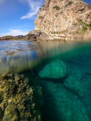 Fototapeta na wymiar The sea and the color in a mediterranean beach under a castle (Scilla south Italy Calabria)