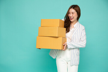 Happy Young Asian woman holding package parcel box isolated on green background, Delivery courier and shipping service concept