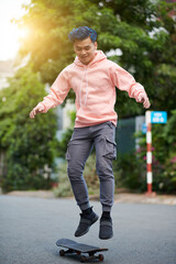 Young man performing stunt on skateboard