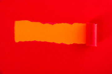 Red torn paper on orange background
