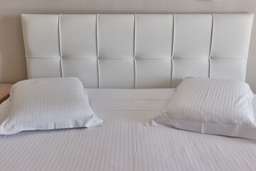 Hotel bed with white sheets