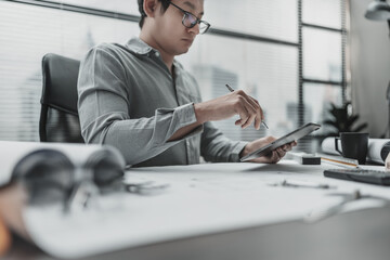 Architect, Engineering working with house drawings inspection on tablet in the office. Engineer,...