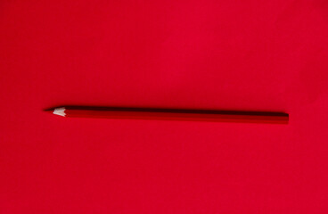 Red color pencil on red background