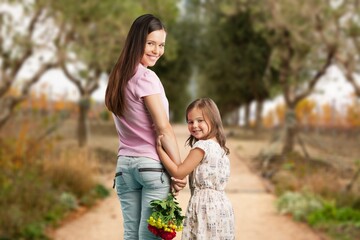 Fototapeta premium Happy young mother and daughter school student go to school