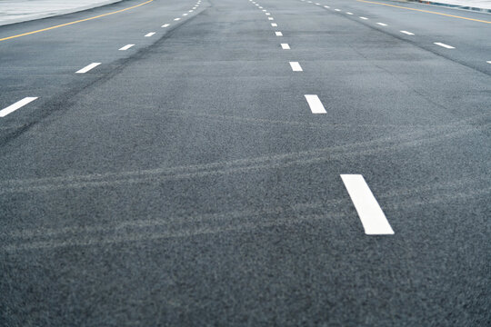 Asphalt road with white dashed lines