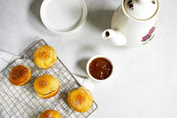 Obraz na płótnie Canvas homemade Algeria Donut with apricot jam and powdered with sugar, reeds plant and coffee