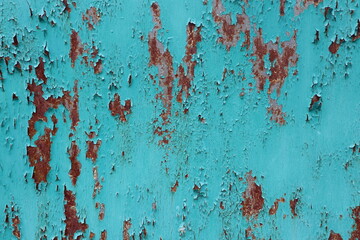 The wall is painted in a bright green color, and there is rust on the wall