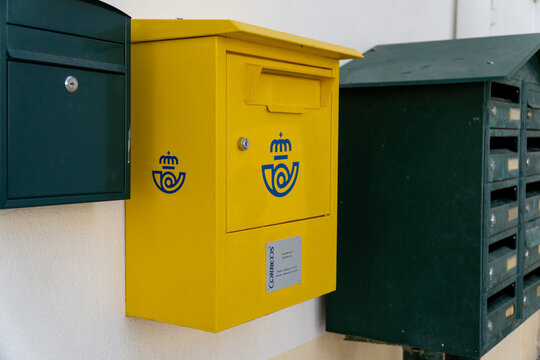 Alcoleja, Alicante, Spain 05 22 2023; Traditional yellow Correos mailbox.