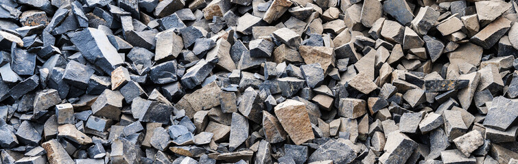 Large gray granite gravel background. Rubble as a background. Building stone.