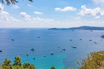 Sea coast on a clear sunny day. Palm trees, sea, yachts. Canary Panorama.