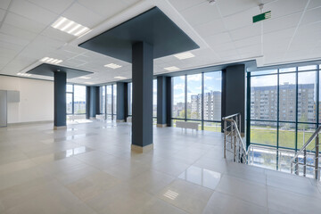 empty modern hall room with columns, doors and panoramic windows.