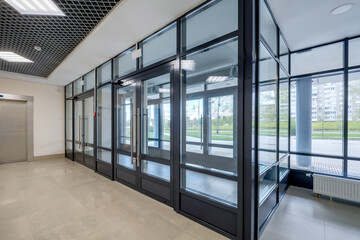 empty modern hall room with columns, doors and panoramic windows.