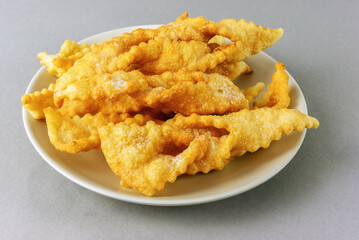 Lithuanian traditional cookies zagareliai with powdered sugar on a plate