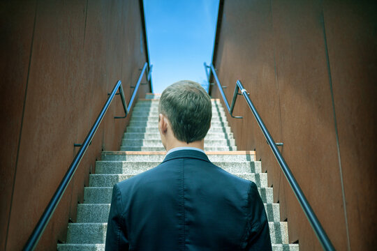 Young Business Man Walking Stepping Going Up The Stairs In Modern City, Go Up, Success, Grow Up. With Filter Tones Retro Vintage. Stairway.